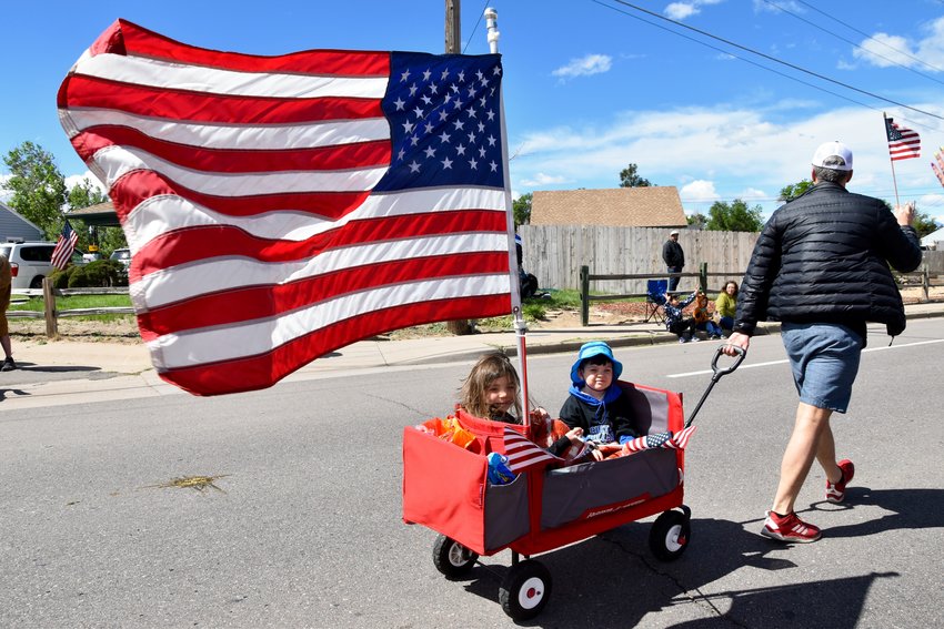 Everette and Noelle Larson have fun riding in the parade to honor those who served.